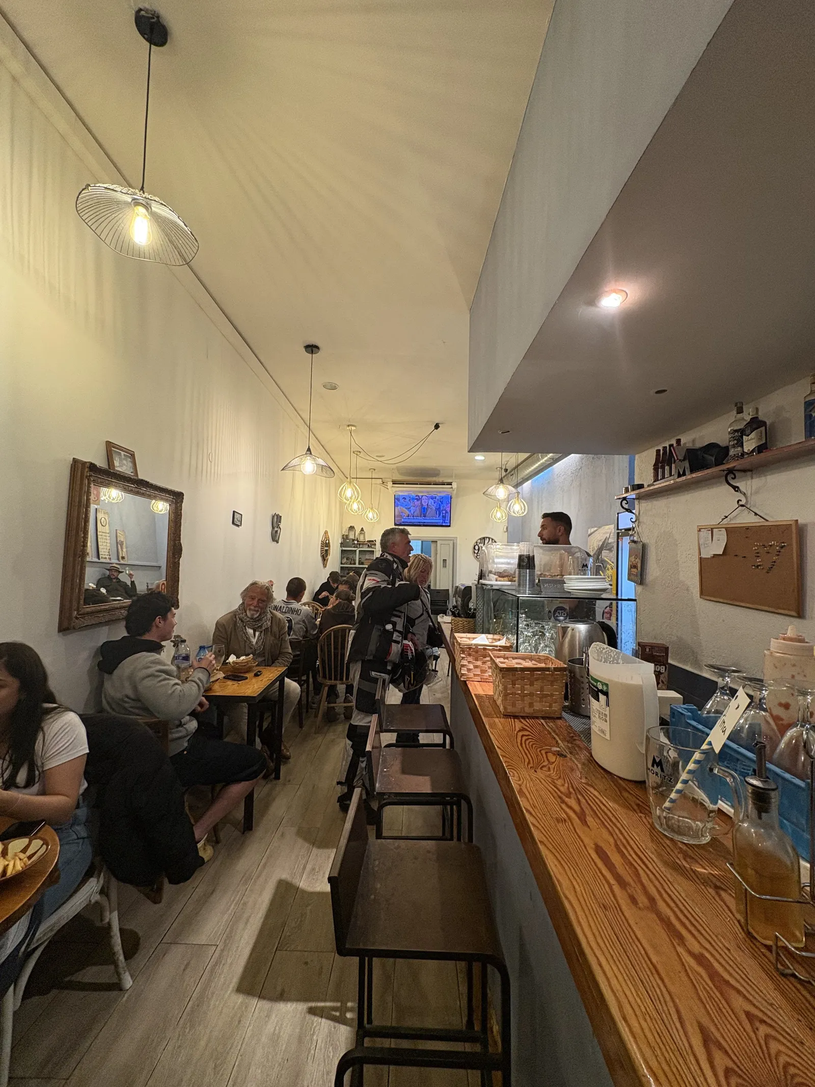 El local per dins: la barra de fusta a la dreta i les taules plenes de clients